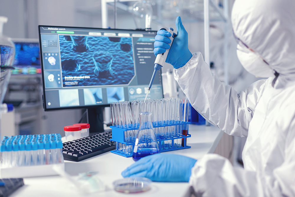 a scientist working in a lab using a syringe and test tubes to research vaccines
